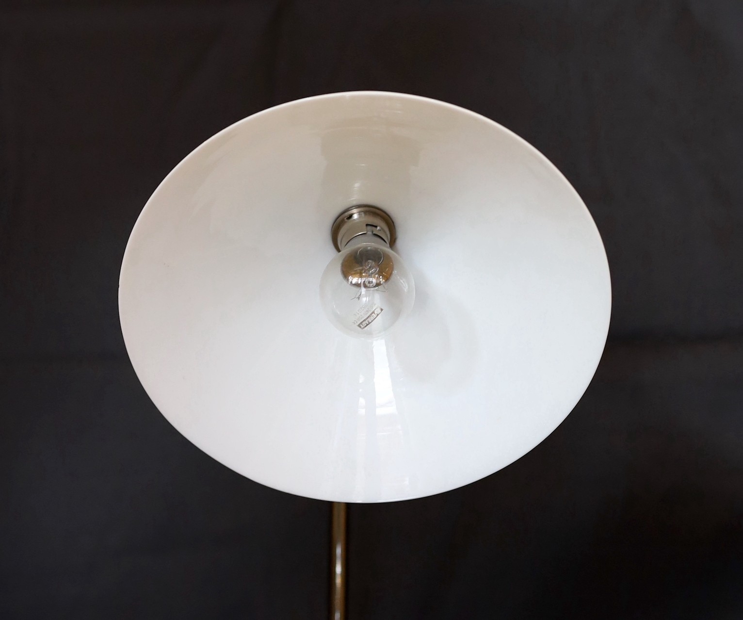 A stylish nickel plated desk lamp, with conical opaque white glass shade and loaded spherical base, height 52cm
